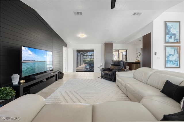 tiled living room with wood walls