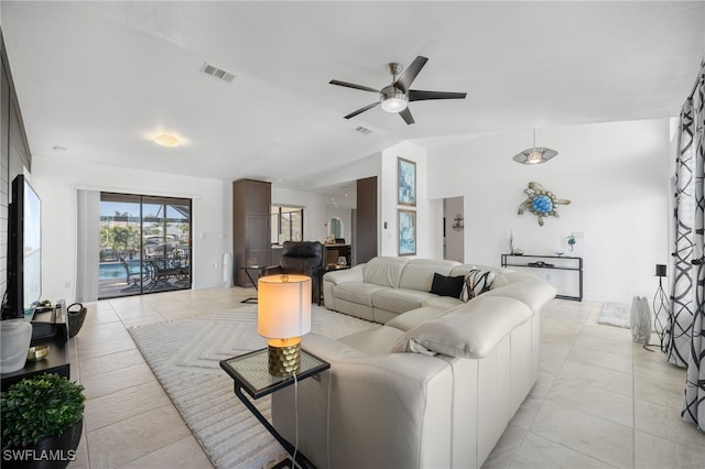 living room featuring ceiling fan and lofted ceiling