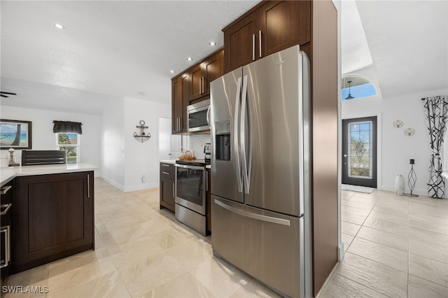 kitchen with dark brown cabinetry and appliances with stainless steel finishes