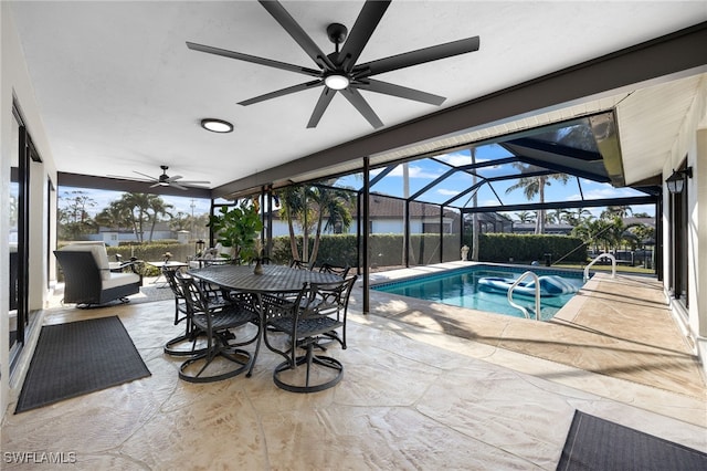 view of pool with glass enclosure and a patio area