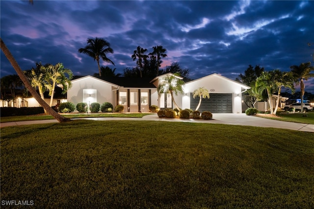 view of front of home featuring a garage and a yard