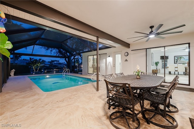 view of swimming pool featuring a patio, a lanai, and ceiling fan