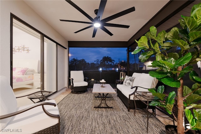 patio terrace at dusk with ceiling fan and an outdoor living space