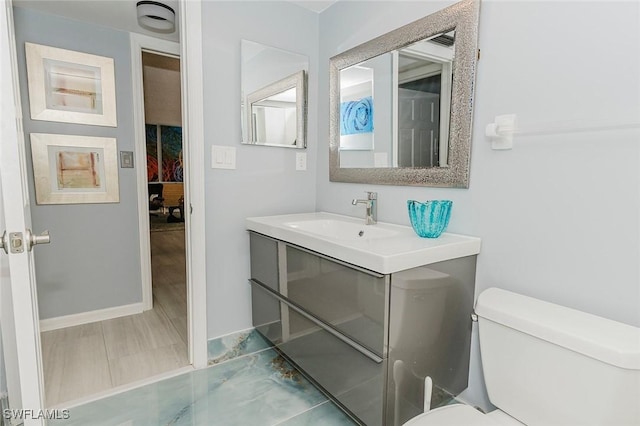 bathroom featuring vanity and toilet