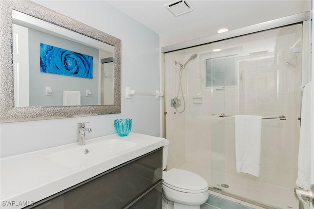 bathroom featuring vanity, toilet, and walk in shower