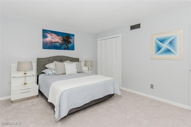 carpeted bedroom with a closet