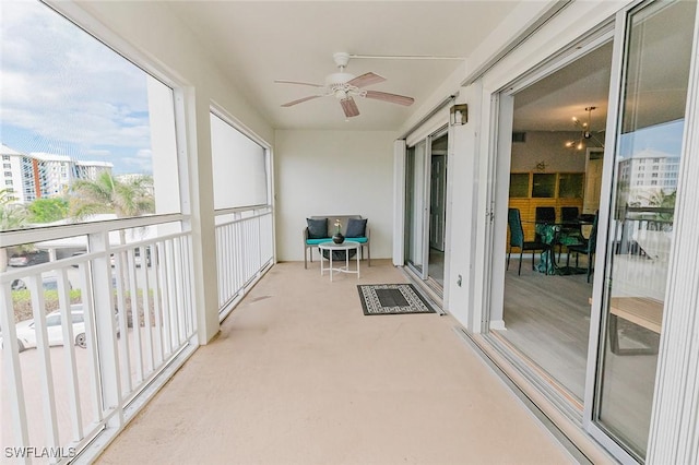 sunroom / solarium featuring ceiling fan