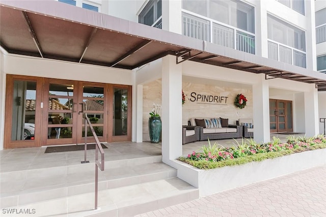 property entrance with an outdoor living space and french doors