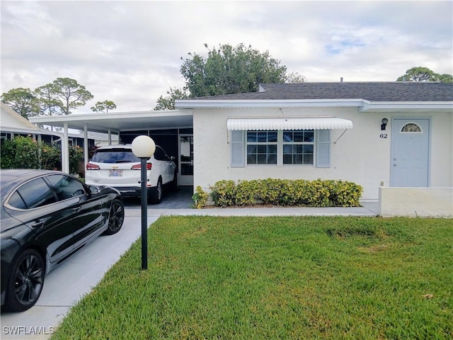 ranch-style house featuring a front yard and a carport