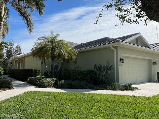 view of property exterior with a lawn and a garage