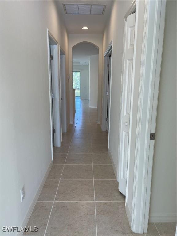 corridor featuring light tile patterned flooring