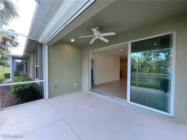 view of patio featuring a lanai and ceiling fan