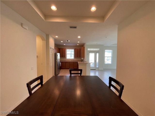 unfurnished dining area with light tile patterned flooring and french doors