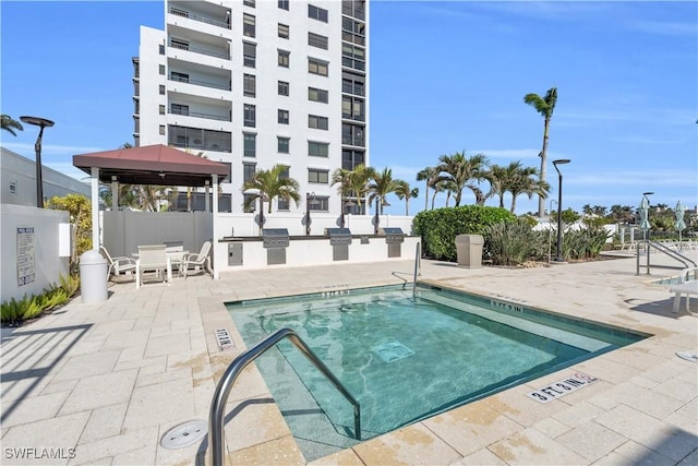 view of swimming pool with a gazebo, area for grilling, and a patio