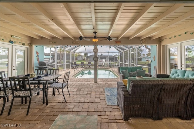 sunroom with beamed ceiling, french doors, a pool, and ceiling fan