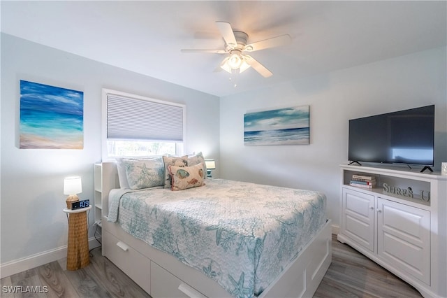 bedroom with ceiling fan and dark hardwood / wood-style floors