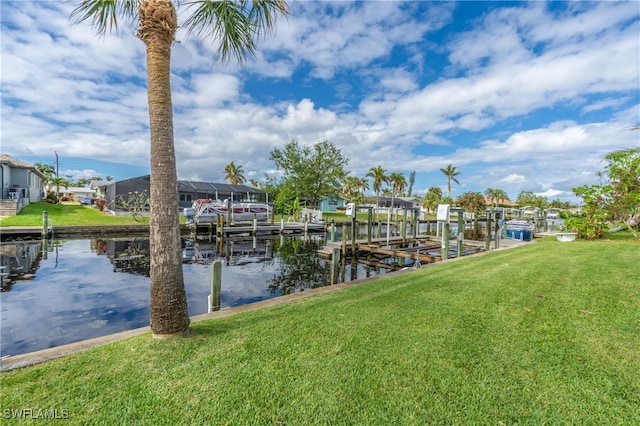 dock area featuring a water view and a lawn