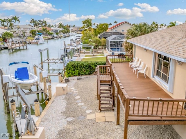 view of patio with a water view and a boat dock