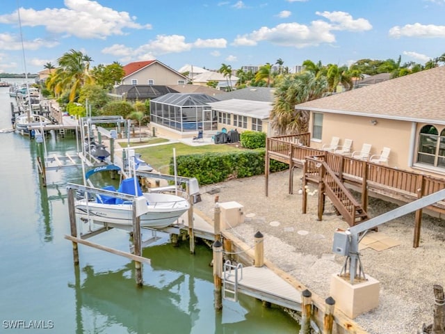 dock area with a lanai and a water view