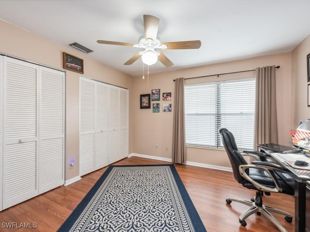 home office featuring hardwood / wood-style flooring and ceiling fan