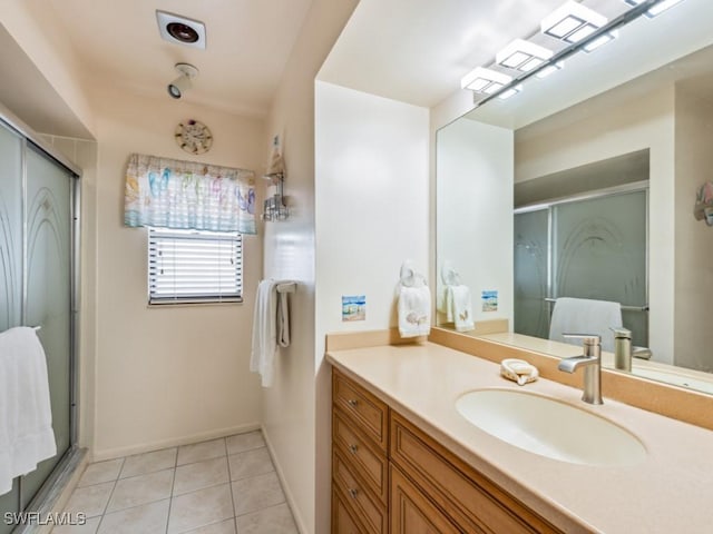 bathroom featuring tile patterned flooring, vanity, and a shower with shower door