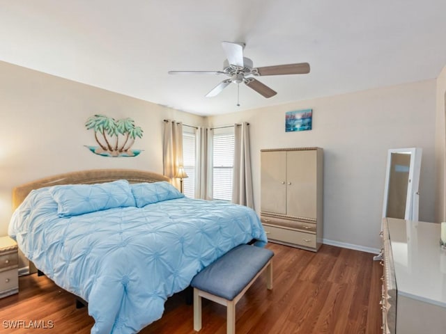 bedroom with ceiling fan and dark hardwood / wood-style flooring