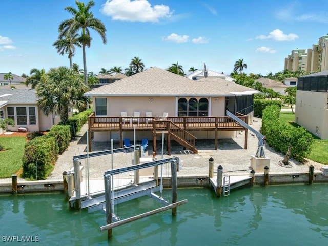 851 Perrine Ct, Marco Island, FL 34145 - rear view of house with boat lift, roof with shingles, stucco siding, a deck, and stairway