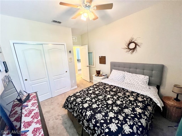 bedroom featuring ceiling fan, a closet, and light carpet