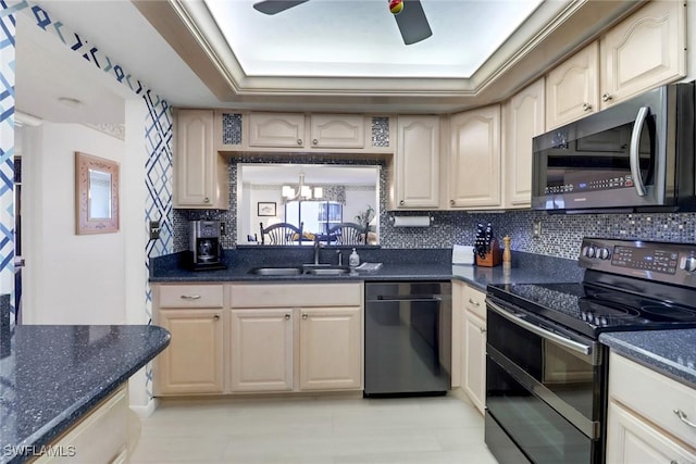 kitchen with double oven range, decorative backsplash, sink, black dishwasher, and dark stone counters