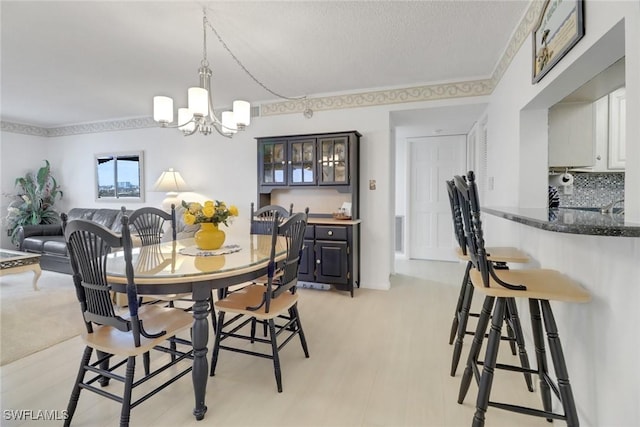 dining area featuring a chandelier and a textured ceiling