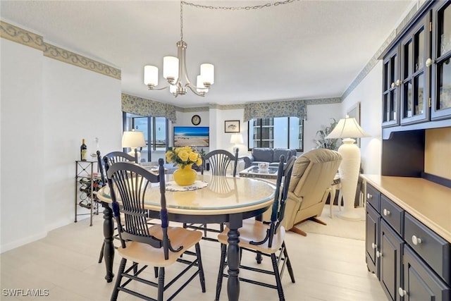 dining space featuring a notable chandelier and light hardwood / wood-style floors