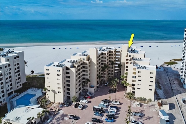 drone / aerial view featuring a beach view and a water view