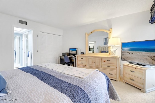 carpeted bedroom with a closet