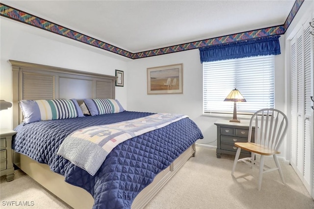 carpeted bedroom featuring a closet