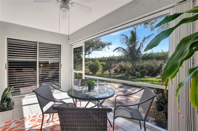 sunroom featuring ceiling fan