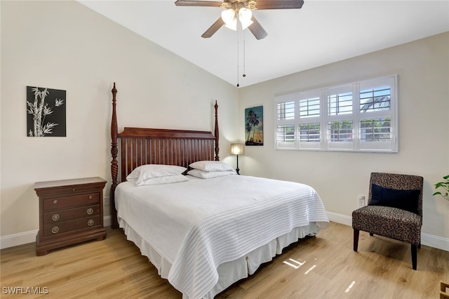 bedroom featuring light hardwood / wood-style flooring, ceiling fan, and lofted ceiling