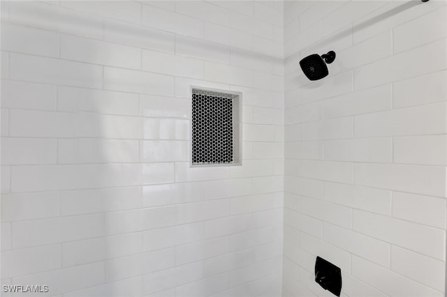 interior details with a tile shower