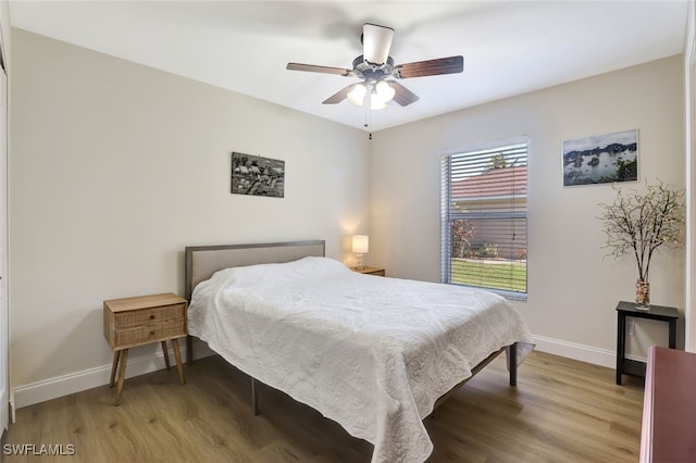 bedroom with ceiling fan and wood-type flooring