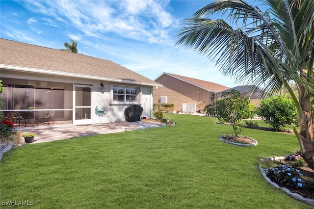 view of yard with a sunroom and a patio area