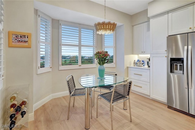 dining space featuring a chandelier and light hardwood / wood-style floors