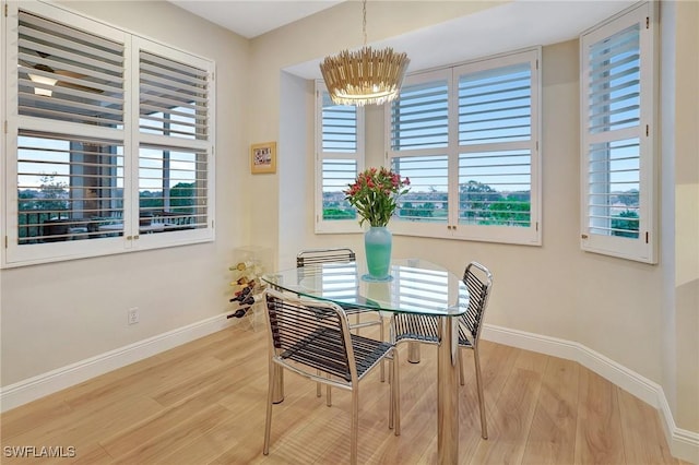 dining space featuring a notable chandelier and hardwood / wood-style flooring