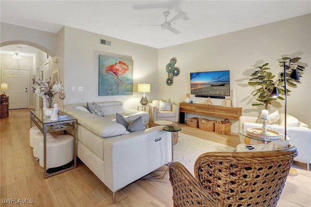 living room featuring light hardwood / wood-style floors and ceiling fan