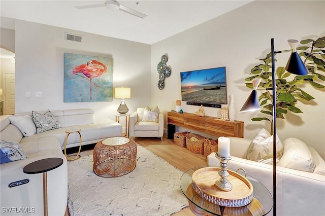 living room with ceiling fan and hardwood / wood-style floors