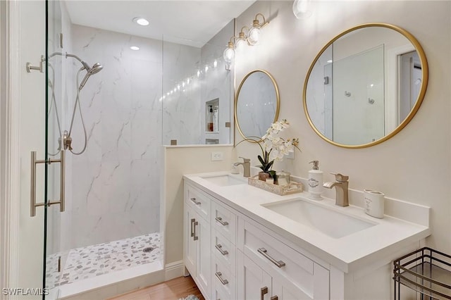 bathroom with vanity and tiled shower