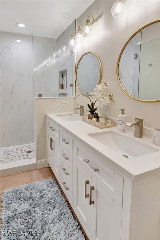 bathroom featuring walk in shower and vanity