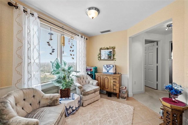 sitting room with plenty of natural light and light tile patterned floors