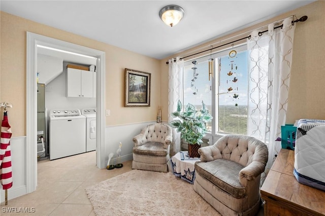 sitting room with light tile patterned floors and washer and clothes dryer