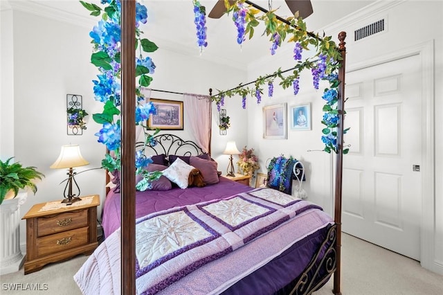 bedroom with light colored carpet, a closet, and crown molding