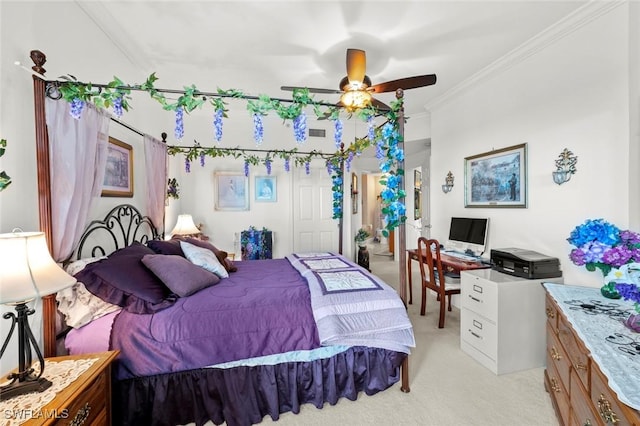 carpeted bedroom with ceiling fan and ornamental molding