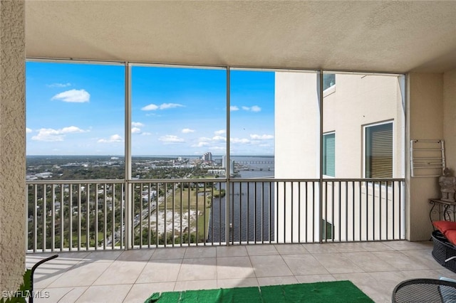 unfurnished sunroom featuring a water view